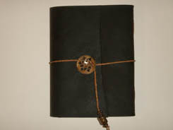 Leather wrapped journal closed and ties with thin leather string